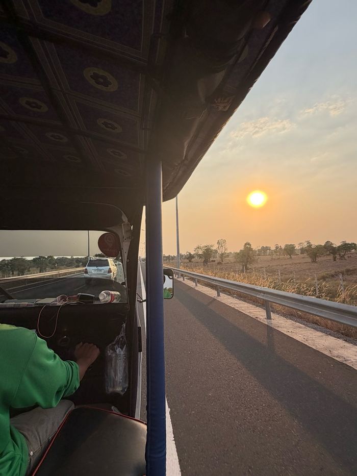 Sunset over the highway, seen from a tuk-tuk on the way into Siem Reap