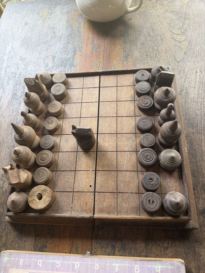 A wooden Khmer chess set on a table