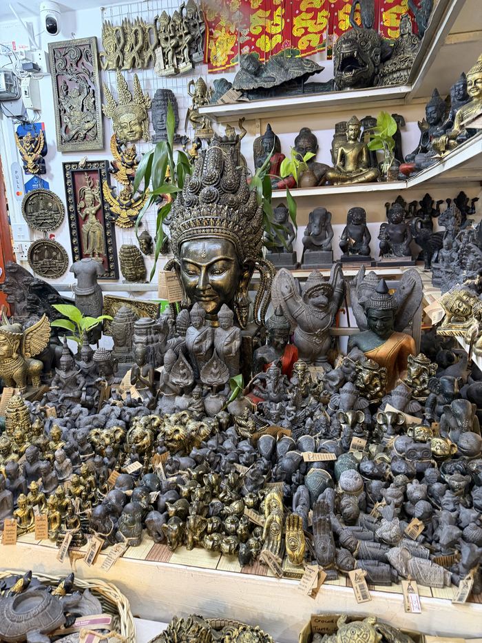 Shelves of statues and carvings for sale at a night market