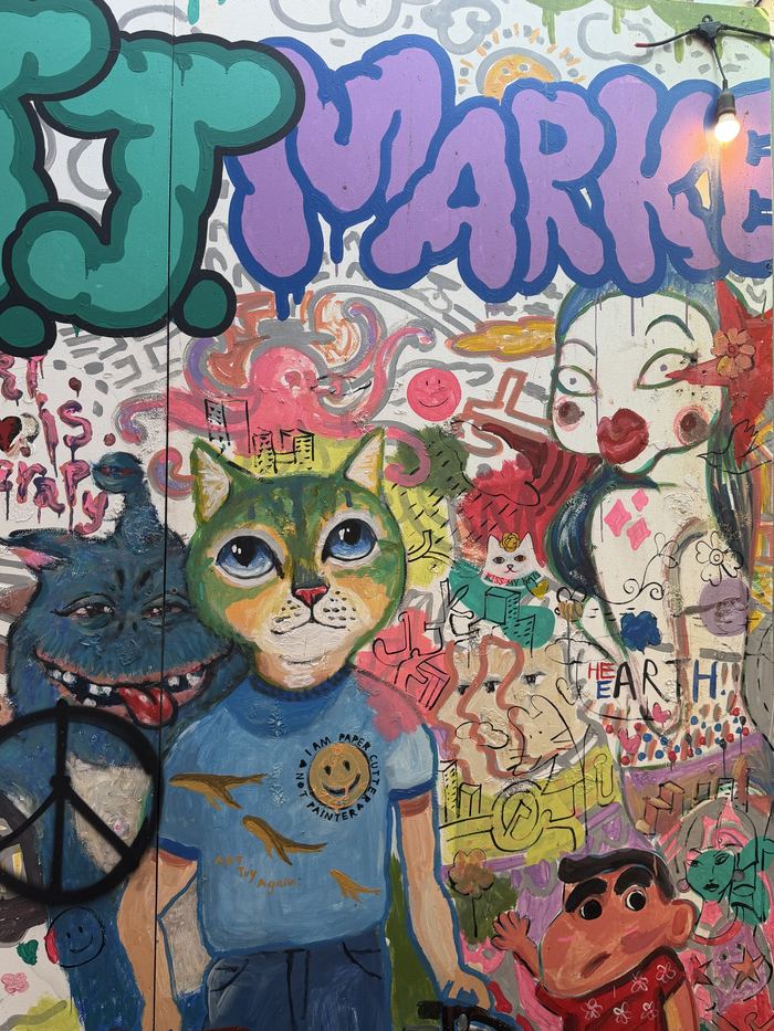 A colorful graffiti mural with cartoon characters