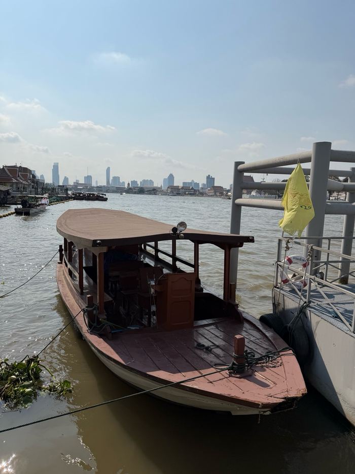 A wooden boat docked on the Chao Phraya River