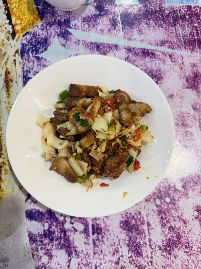 A plate of crispy pork tossed with herbs and chili