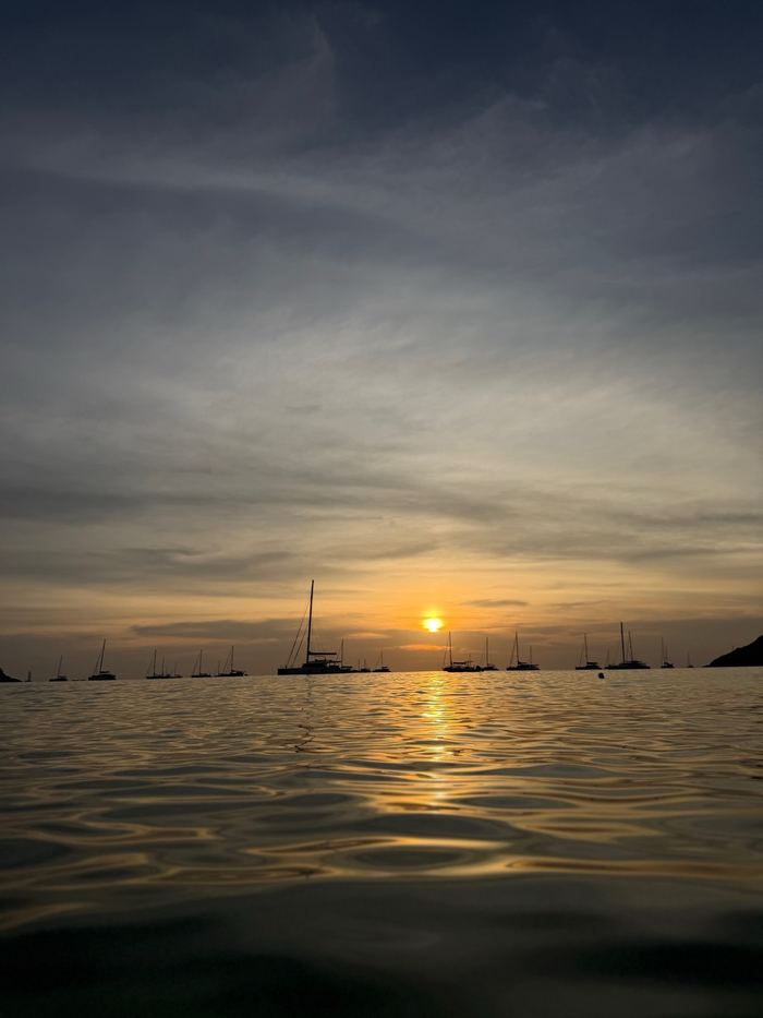 Sunset over the Andaman Sea with boats on the horizon