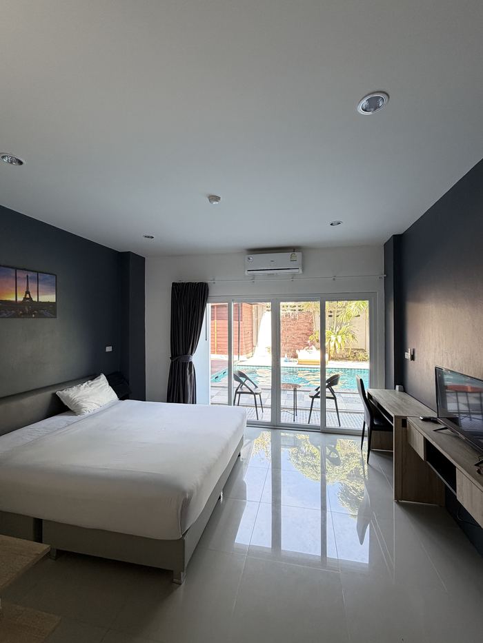 A clean, modern hotel room with a balcony