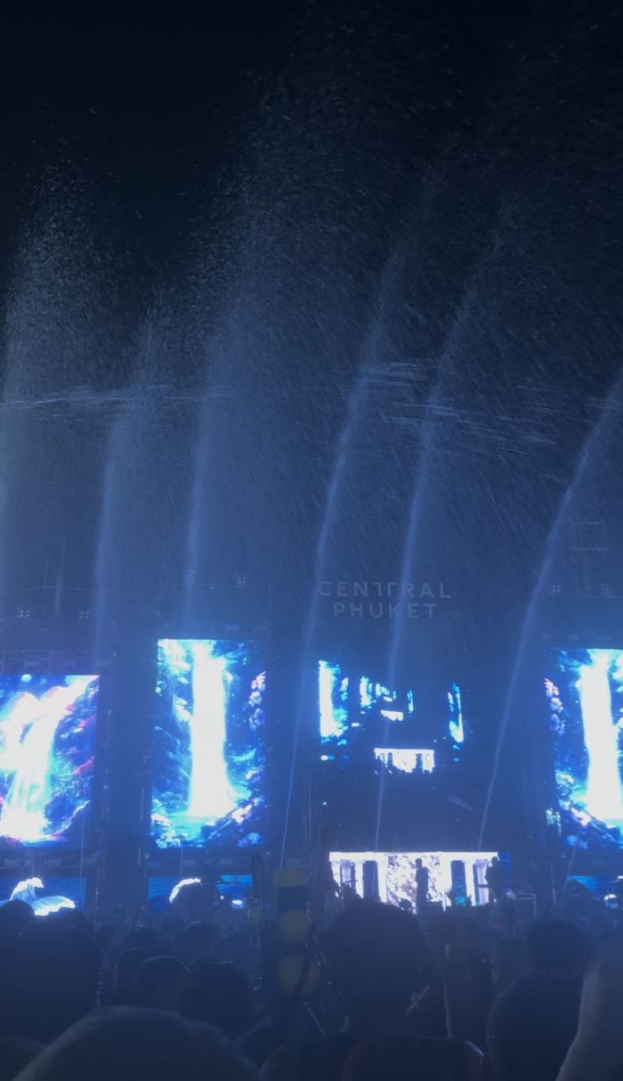 Water jets and screens at a Songkran concert at night