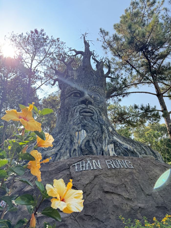 A carved tree-spirit sculpture labeled Than Rung