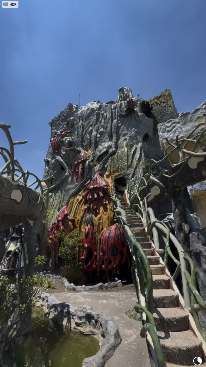 A narrow staircase winding up a cave-like structure