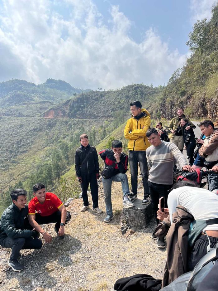 The tour group taking a break on a mountain road