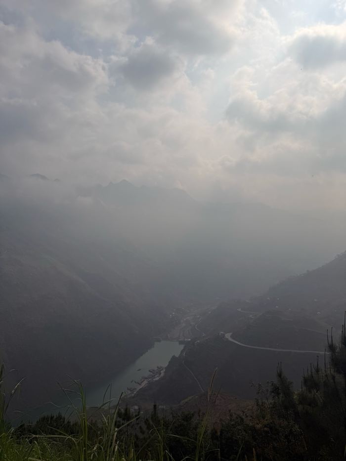 A river winding through a hazy canyon