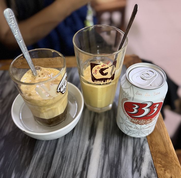 Egg coffee, a glass of egg cream, and a can of 333 beer