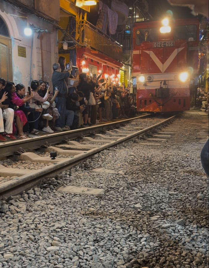 A train passing inches from people on Hanoi's Train Street