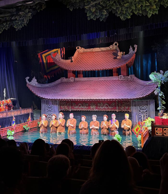 The cast taking a bow at a water puppet show