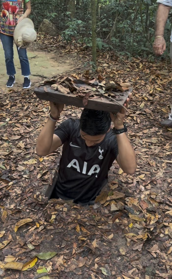 Squeezing into a hidden tunnel entrance in the leaves