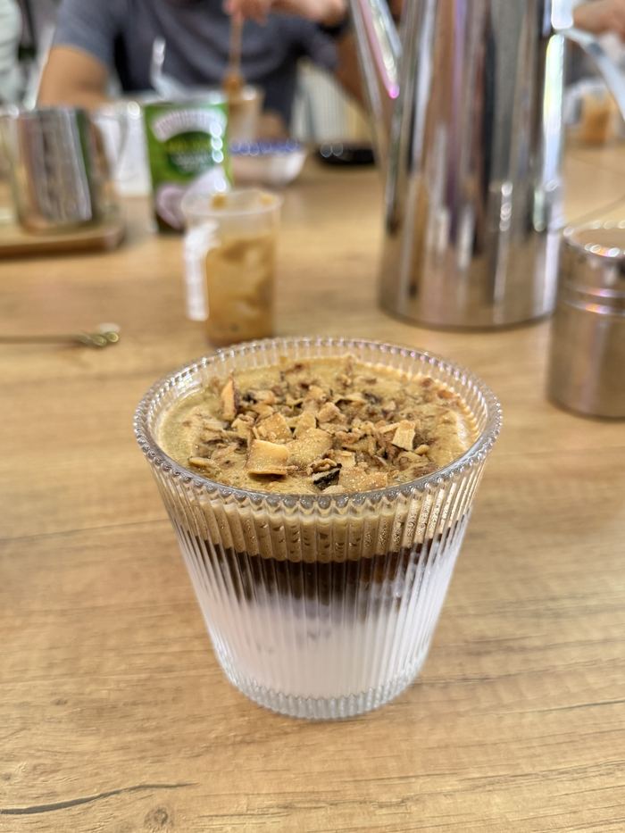 A layered coconut coffee in a glass