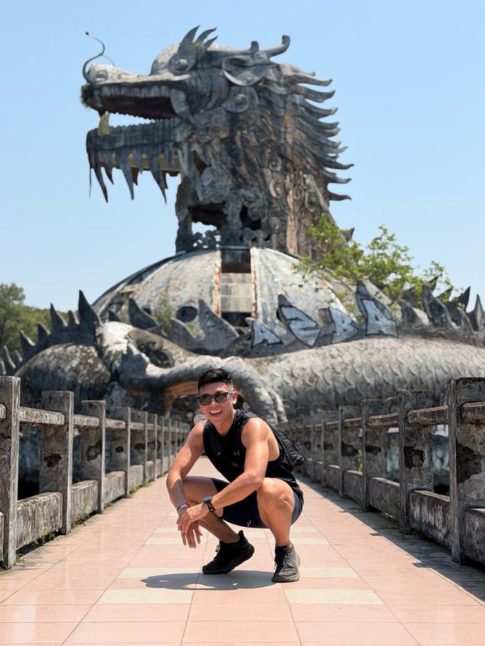 Posing in front of a giant dragon statue at an abandoned water park