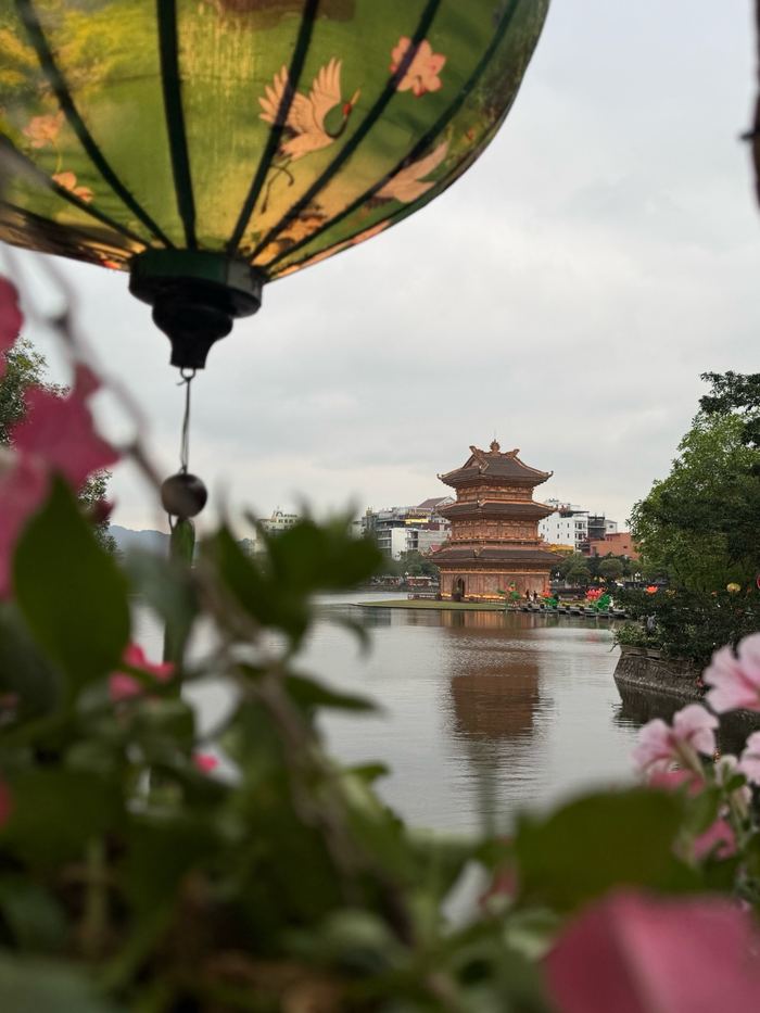 A lantern and pagoda across the water in Ninh Binh