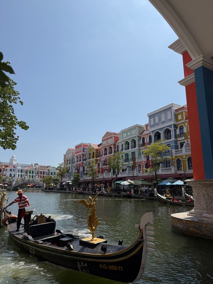 A gondola on a canal lined with colorful buildings