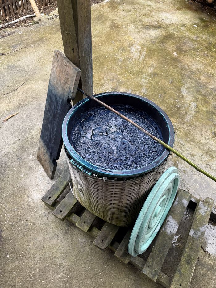 A basket vat of natural indigo dye